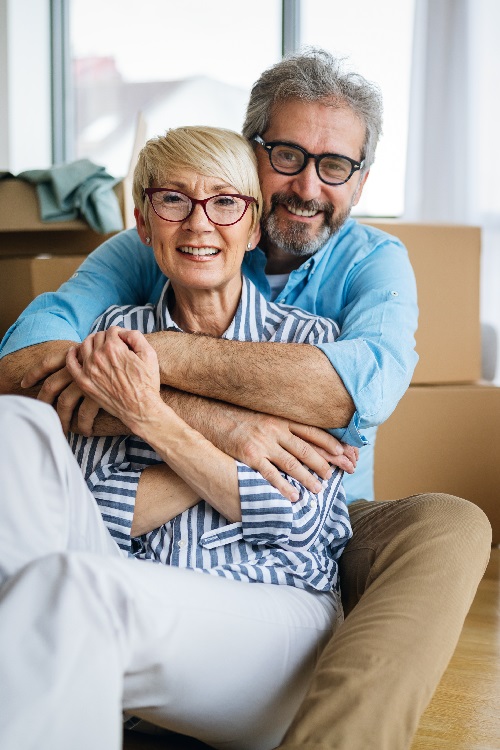 Happy retired senior couple moving into a new home, apartment.